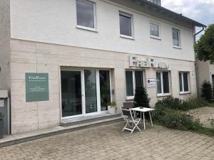 a building with a table in front of it at FreiRaum in Vöhringen
