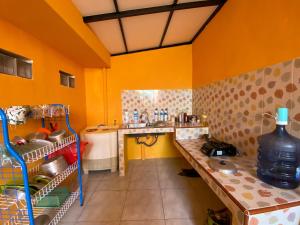 a small kitchen with yellow walls and a sink at Villa Satita Murah Batu in Batu