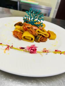 a white plate with a piece of food on it at Admiral Hotel Villa Erme in Desenzano del Garda