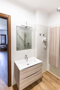 a bathroom with a sink and a mirror at Affittacamere Cigui in Muggia