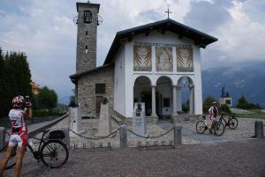 two people on bikes in front of a church at PROVINCIALE 79 in Magreglio