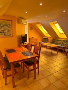 a living room with a table and chairs and a couch at Apartment Roman villa in Hévíz