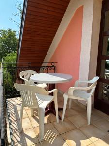 a white table and chairs on a balcony at Apartment Roman villa in Hévíz