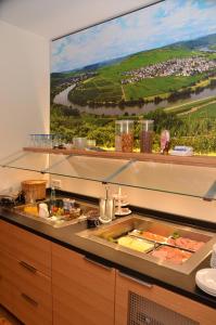 a kitchen with a large window with food on a counter at Seminarshof in Trittenheim