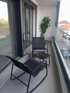 two chairs and a table on a balcony at Bragança Holiday Home new apartment with 2 bedrooms private parking in Bragança