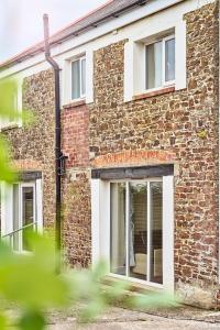 a brick building with a window on it at The Barn (Chilsworthy), 6 Sleeper House, 19 Min Drive into Bude, Cornwall in Holsworthy