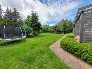a yard with a gazebo and a playground at Domki Letniskowe Flauta in Grzybowo