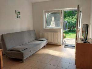 a living room with a couch and a window at Domki Letniskowe Flauta in Grzybowo