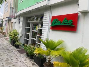 a store with a sign on the side of a building at Niu Inn & Spa in Hulhumale