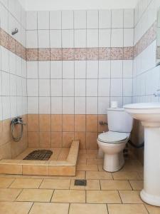 a bathroom with a tub and a toilet and a sink at Villa Zerva in Leptokaria