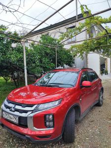 a red car parked in front of a house at House Dea Dea in Chakvi