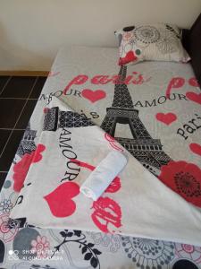 a bed with a blanket with the eiffel tower at apartman Dragic in Budva