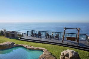 a swimming pool with a view of the ocean at Garvies Surf house in Durban