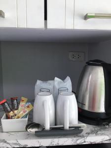 two white kettles on a counter in a kitchen at Anantra Pattaya Resort in Pattaya
