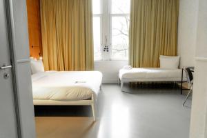 a hotel room with two beds and a window at Conscious Hotel Westerpark in Amsterdam