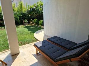 a couch sitting on a porch with a view of a yard at Apartments Cerin-Rovinj in Rovinj