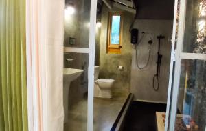 a bathroom with a shower and a toilet and a sink at Rain Forest Star in Deniyaya