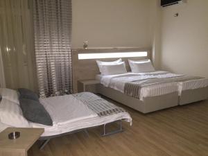 Letto o letti in una camera di Hotel Martini Kvariati