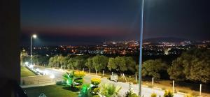 a view of a city at night with lights at Villa Elite in Kusadası