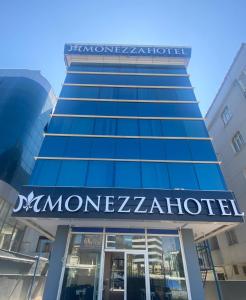 un edificio con un cartello sul lato di Monezza Hotel Maltepe a Istanbul