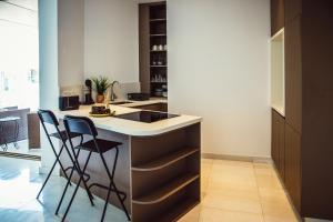a kitchen with a counter and two stools at Phaedrus Living: 360 Tower Luxury Flat in Nicosia
