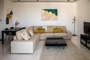 a living room with a couch and a table at Phaedrus Living: 360 Tower Luxury Flat in Nicosia