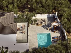an overhead view of a swimming pool in a house at Kapodistria Luxury Villas - 3-Bedroom Villas with Private Pool, by ZanteWize in Planos