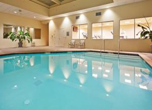 a large swimming pool in a hotel room with blue water at Crowne Plaza San Francisco Airport, an IHG Hotel in Burlingame