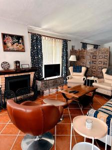 a living room with a couch and a tv at Casa Girassol with a beautiful private Pool and Garden in Sintra