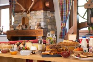 a table topped with lots of different types of food at Le Rêve in Courmayeur +14 photos