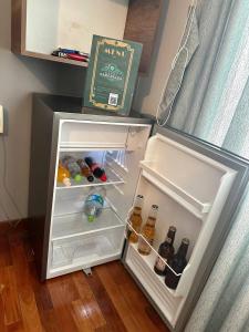 an open refrigerator filled with bottles of alcohol at Hotel Esmeralda in La Paz