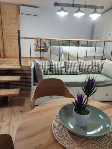 a living room with a couch and a table at Studio al Mulino in Rovinj +6 photos