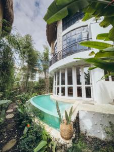 a house with a swimming pool in front of it at Hillstone U Villa in Uluwatu