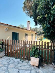 a wooden fence in front of a house at Casa Girassol with a beautiful private Pool and Garden in Sintra