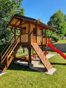 a playground with a slide and a play structure at Casa Izvorul Rarăului in Câmpulung Moldovenesc