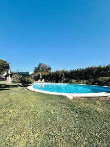 a swimming pool in the middle of a yard at Casa Girassol with a beautiful private Pool and Garden in Sintra