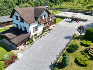 an aerial view of a house with a gravel driveway at Casa Izvorul Rarăului in Câmpulung Moldovenesc