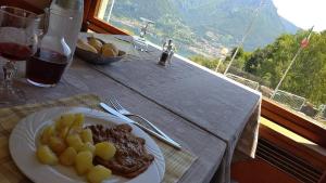 a plate of food on a table with a glass of wine at PROVINCIALE 79 in Magreglio