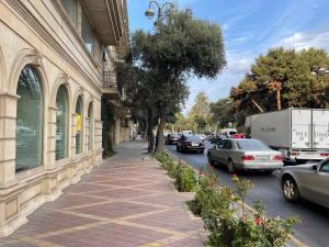 a street with cars parked on the side of a building at Sahil Lux in Baku