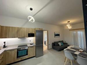 a kitchen and living room with a couch and a table at Villa Rodelia in Roda