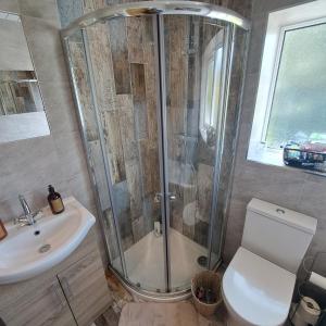 a bathroom with a shower and a toilet and a sink at Oakworth in Oakworth
