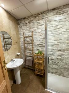 a bathroom with a white sink and a shower at Casa Almanzora, apartamento de 1 dormitorio, wifi, parking gratuito in Zurgena +13 photos
