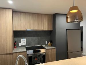 a kitchen with a stove and a refrigerator at Nouveau Condo Québec in Quebec City