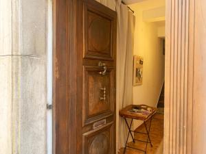 a wooden door in a hallway with a table at La Demeure du Pont Vieux in Collobrières