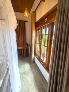 a room with windows and a white curtain at Calm Retreat in Mirissa