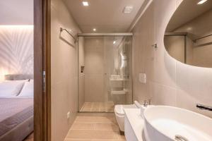 a bathroom with a tub and a sink and a shower at Amalia's Luxury Apartment 1 in Heraklio