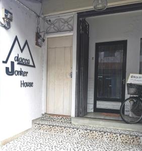 a front door of a coffee house with a bike parked outside at Malacca Jonkerhouse in Malacca