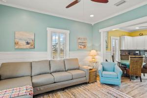 a living room with a couch and a blue chair at Alister House in Port Aransas
