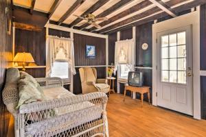 a living room with a couch and a tv at Beachfront Connecticut Retreat with Views! in Milford