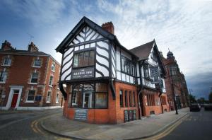 a black and white building on the corner of a street at The Saddle Inn in Chester